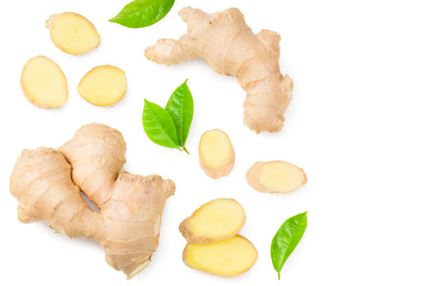 istock ginger roots with slices and green leaves isolated on white background. Top view 1256556996