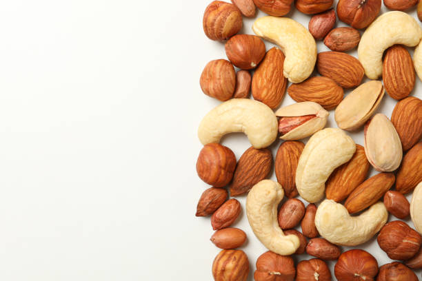 istock Different tasty nuts on white background. Vitamin food 1256556998