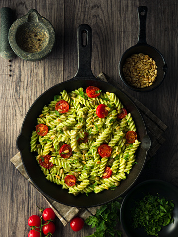 Home made freshness fusilli pasta with vegan broccoli pesto sauce and roasted pine nuts and cherry tomato