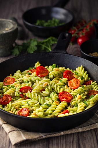 Home made freshness fusilli pasta with vegan broccoli pesto sauce and roasted pine nuts and cherry tomato