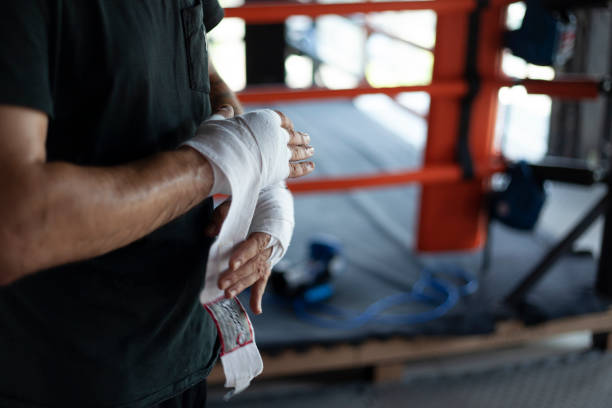 istock man doing sports wraps bandages on his hands 1256557753