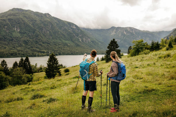 istock Young couple admiring scenic views while hiking 1256558635