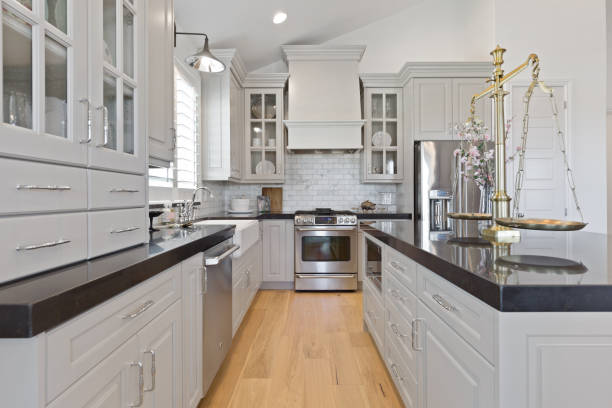 istock Gray kitchen with vaulted ceiling and wall sconce above farmhouse sink 1256558850