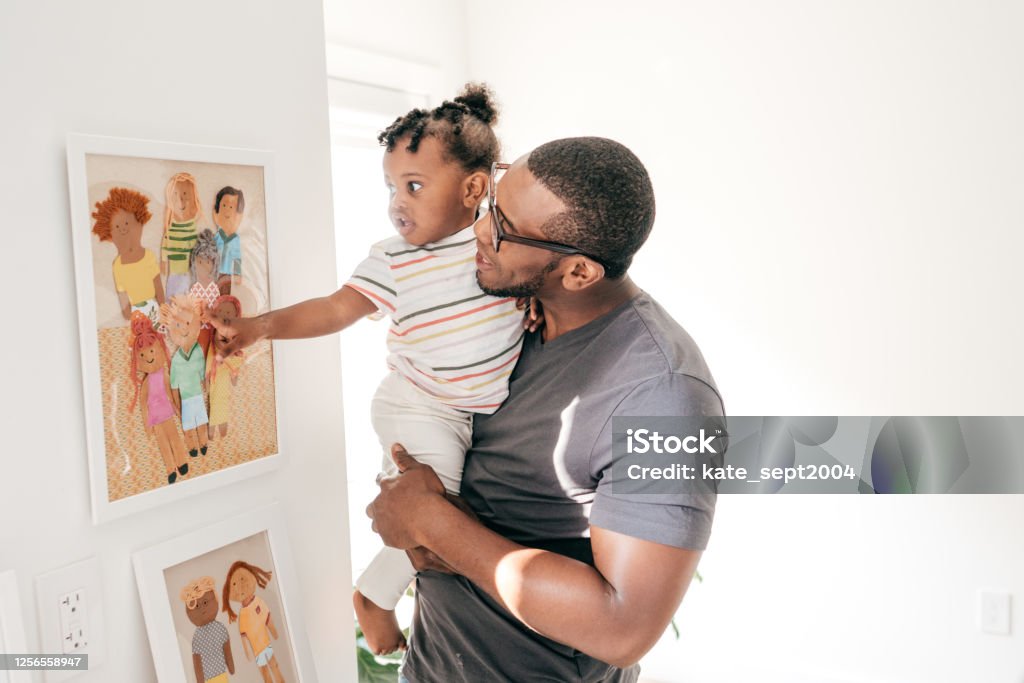 Learning moment for toddler Emotional development for the toddler- dad showing pictures Toddler Stock Photo