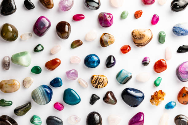 istock Colorful semi-precious stones arranged neatly on a white background 1256559167