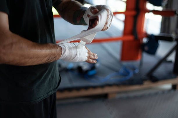 istock man doing sports wraps bandages on his hands 1256560263