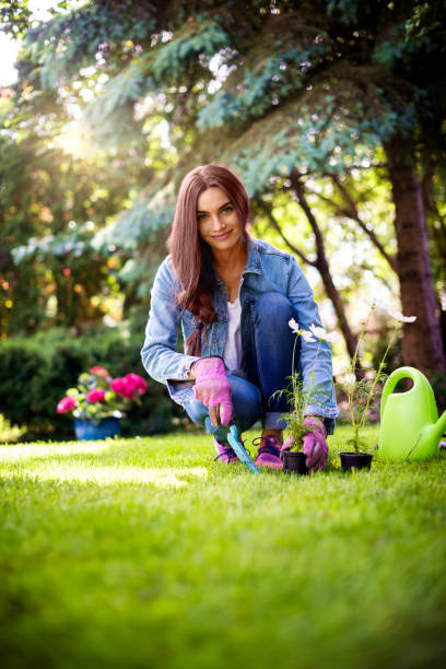 istock Young woman gardening at home 1256560326