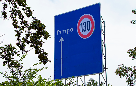 german highway direction sign, changed to speed limit 130 advice, outdoors