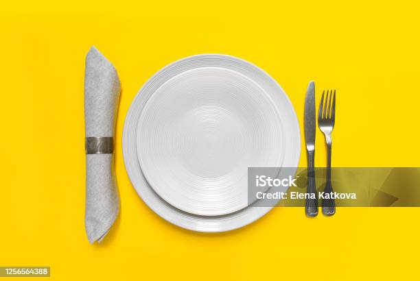 White Plate On Yellow Background Stock Photo - Download Image Now - Setting The Table, Yellow, Sparse