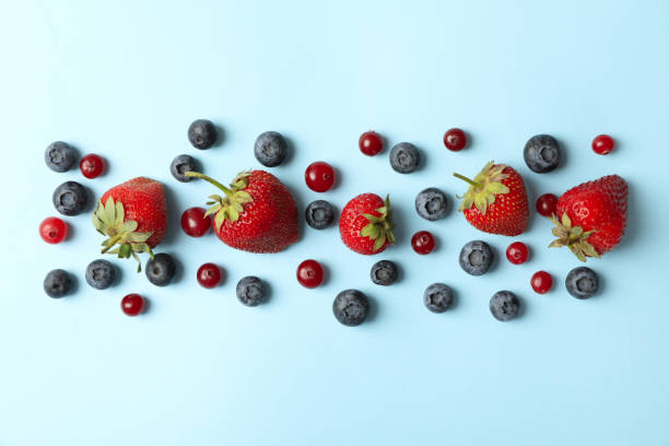 istock Flat lay with fresh berries on blue background, top view 1256564589