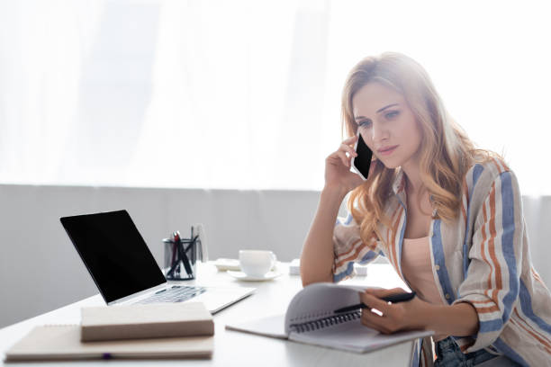 istock Selective focus of pretty freelancer working with notebook and digital devices 1256567228