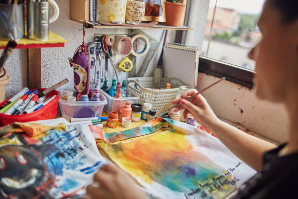 istock Female painter working in a workshop with watercolors 1256569145