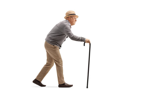 istock Elderly man walking with a walking cane 1256569970