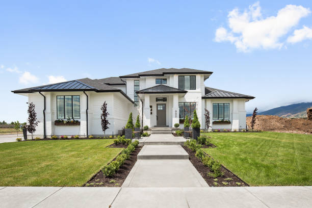 istock Front exterior of newly constructed modern home with many quality windows 1256570281