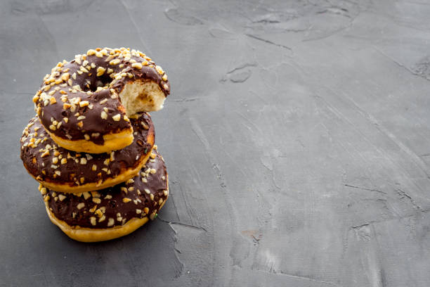 istock Chocolate donuts close up. Glazed and sprinkles bakery 1256572471