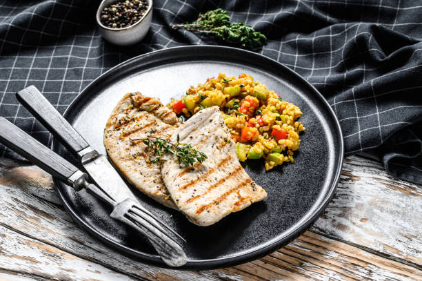 istock Roast Turkey meat Steaks with quinoa. White background. Top view 1256572664