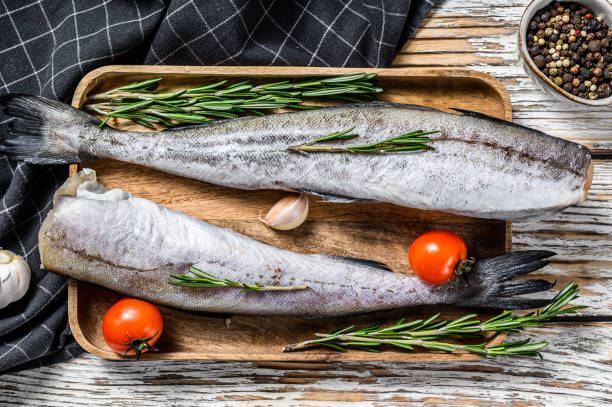 istock Whole fish Pollock. Raw seafood. White background. Top view 1256572798