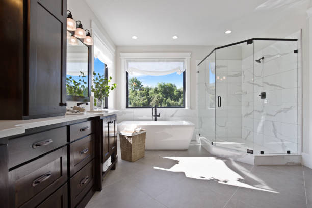 istock Modern luxury in master bathroom with large glass shower 1256574533