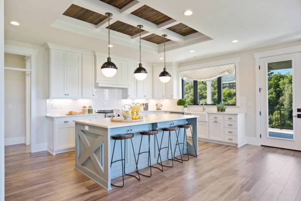 White gourmet kitchen with farmhouse sink Beautiful pendant lights with wood paneled coffered ceiling bar stool photos stock pictures, royalty-free photos & images