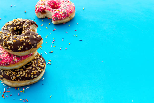 istock Colorful donuts close up, glazed and sprinkles bakery 1256575656