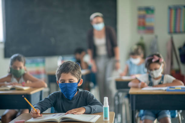 istock Elementary students in the classroom wearing masks 1256576812