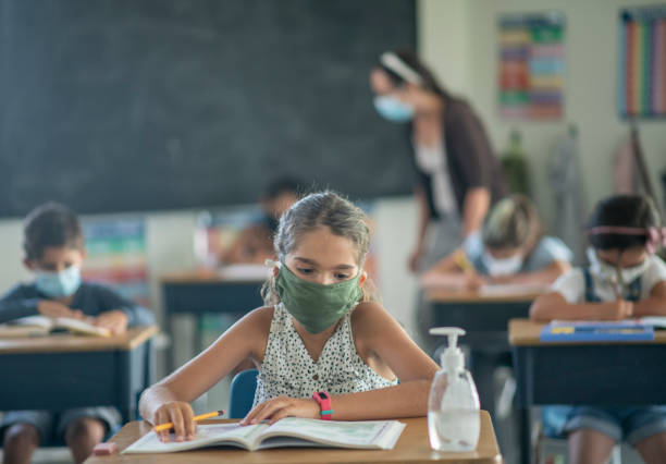 istock Elementary students in the classroom wearing masks 1256576815