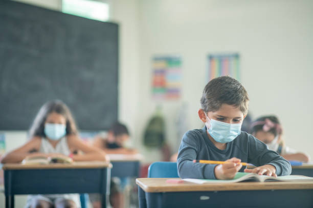istock Elementary students in the classroom wearing masks 1256576834