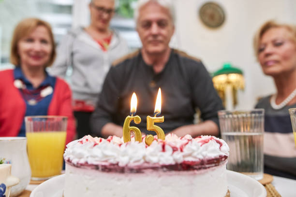 istock Cake and candles on a senior birthday party 1256580348