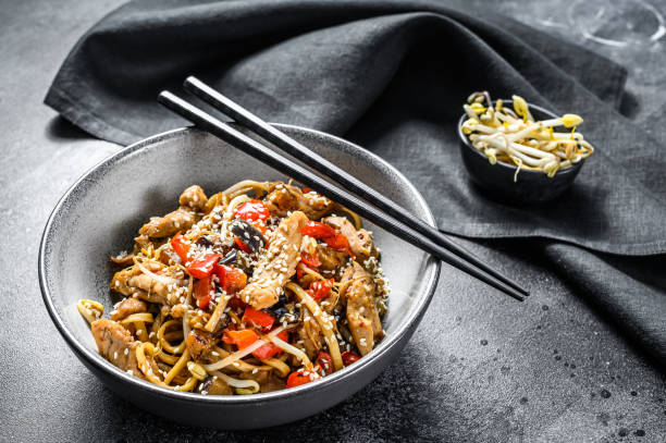 chicken stir-fry. wok udon noodles. traditional asian food. black background. top view - teriyaki broccoli carrot chicken imagens e fotografias de stock