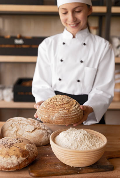 istock Little baker showing loaf of bread 1256584928