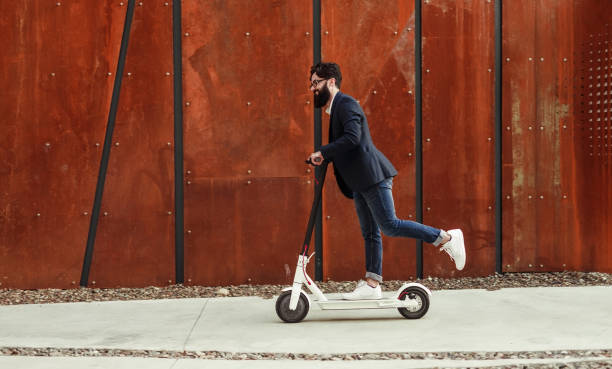 istock Cheerful hipster riding electric scooter 1256584980