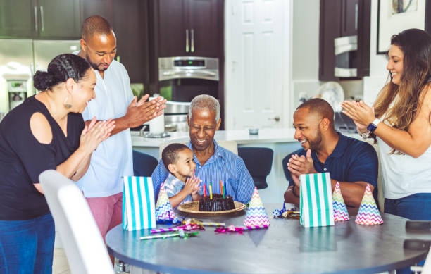 mehrgenerationen-afrika-familie feiert geburtstag - long life cake birthday cake grandparent stock-fotos und bilder