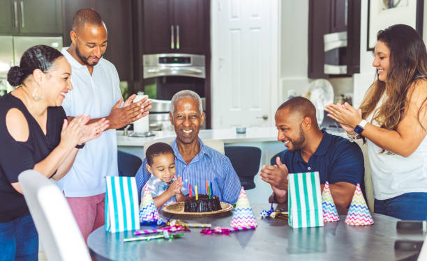 mehrgenerationen-afrika-familie feiert geburtstag - long life cake birthday cake grandparent stock-fotos und bilder