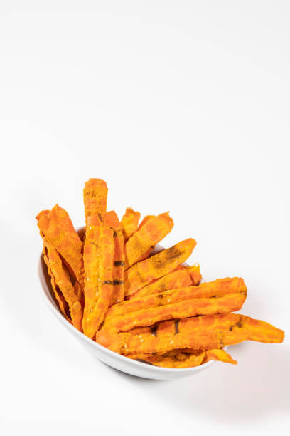 istock Bowl of roasted carrots isolated on a white background 1256591949