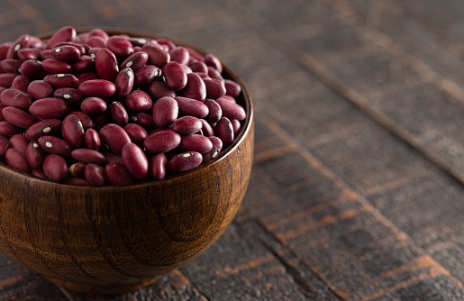 A Bowl of Red Kidney Beans on a Rustic Wooden Table