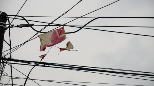 Kite trapped on electric pole stock photo