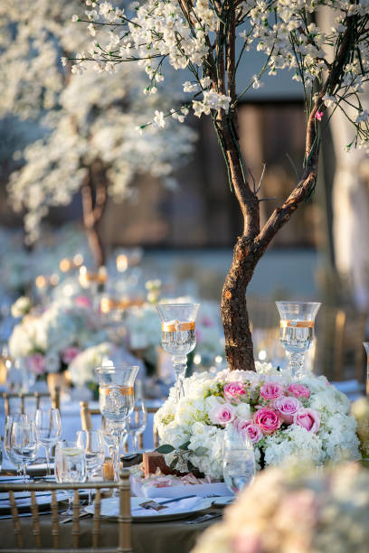 istock Outdoor wedding ceremony table setting in the springtime decoracted with white and pink roses 1256612554