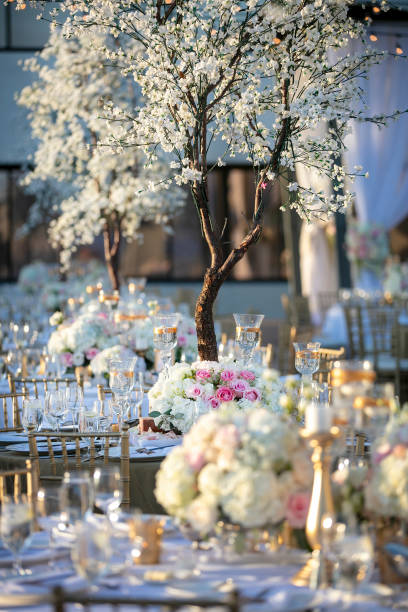 istock Outdoor wedding ceremony table setting in the springtime decoracted with white and pink roses 1256612555