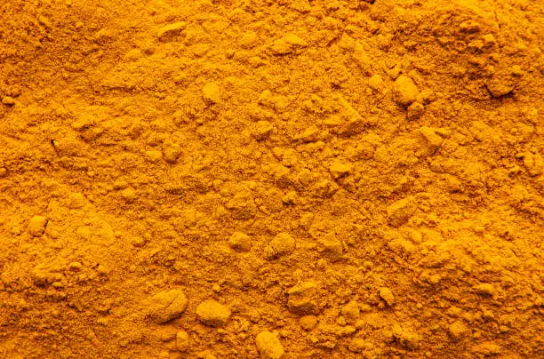 Background made of yellow turmeric powder