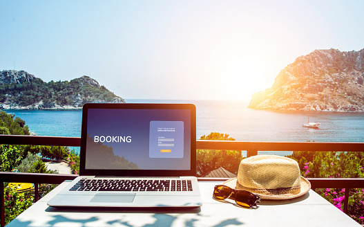 Travel booking web page concept. Booking on the internet. Laptop mock-up with sea view