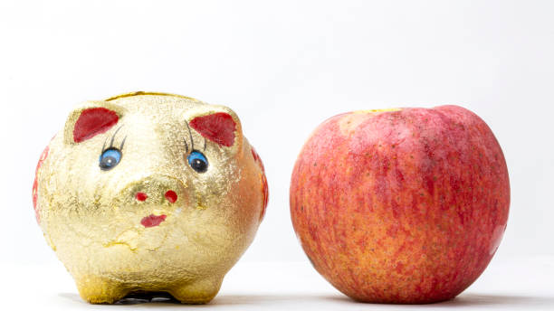 piggy bank and apple isolated on white