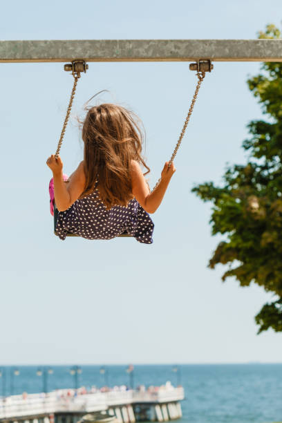 istock Girl swinging on swing-set. 1256624139