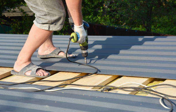istock A building contractor is installing box profile sheeting, paint coated metal roofing sheets on the rooftop of the house using an electric screwdriver. 1256625046