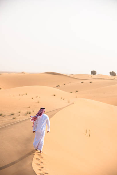 istock arabic man walking in the desert 1256625193