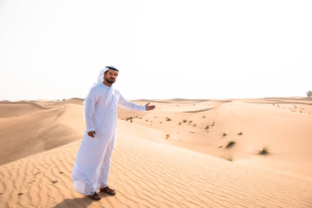 istock arabic man walking in the desert 1256625309