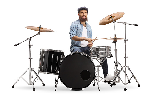 Bearded musician playing a set of drums isolated on white background
