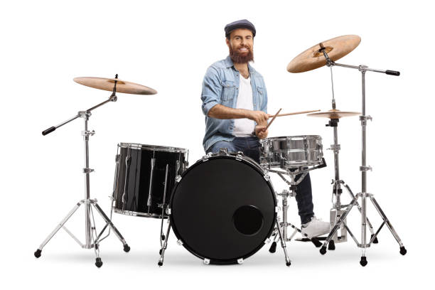 Bearded musician playing a set of drums Bearded musician playing a set of drums isolated on white background drummer stock pictures, royalty-free photos & images