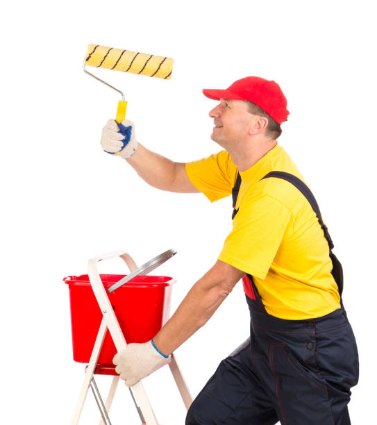 istock Worker on the ladder with the paint roller. 1256627823