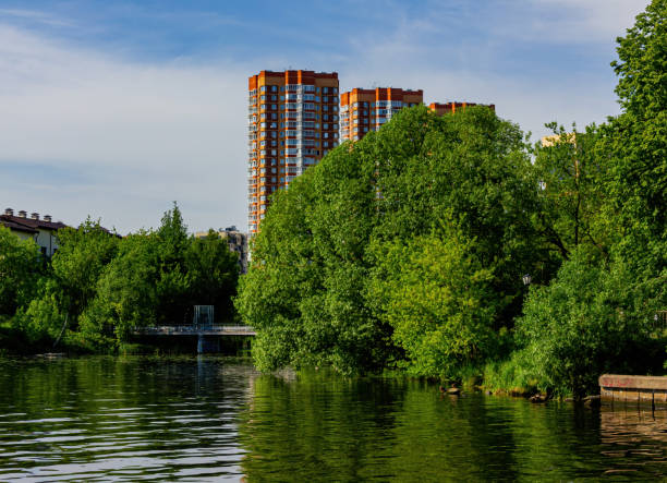 istock Landscape with a residential complex on the river Bank with a blue sky. 1256628207