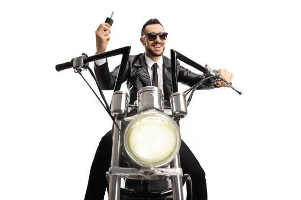 istock Biker riding a custom chopper and holding a key 1256628747